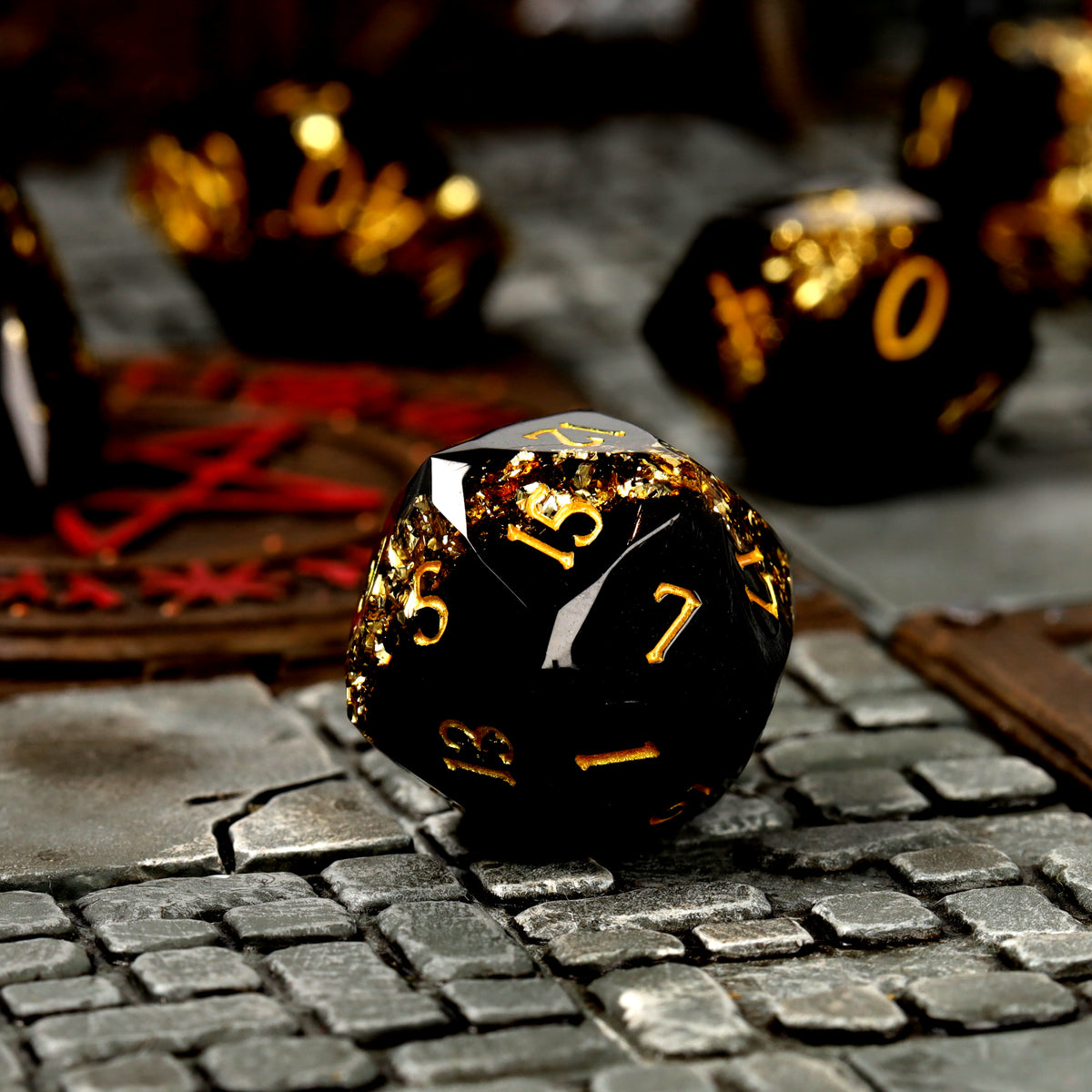Topaz Trail d20 close-up, black resin with a gold mica band